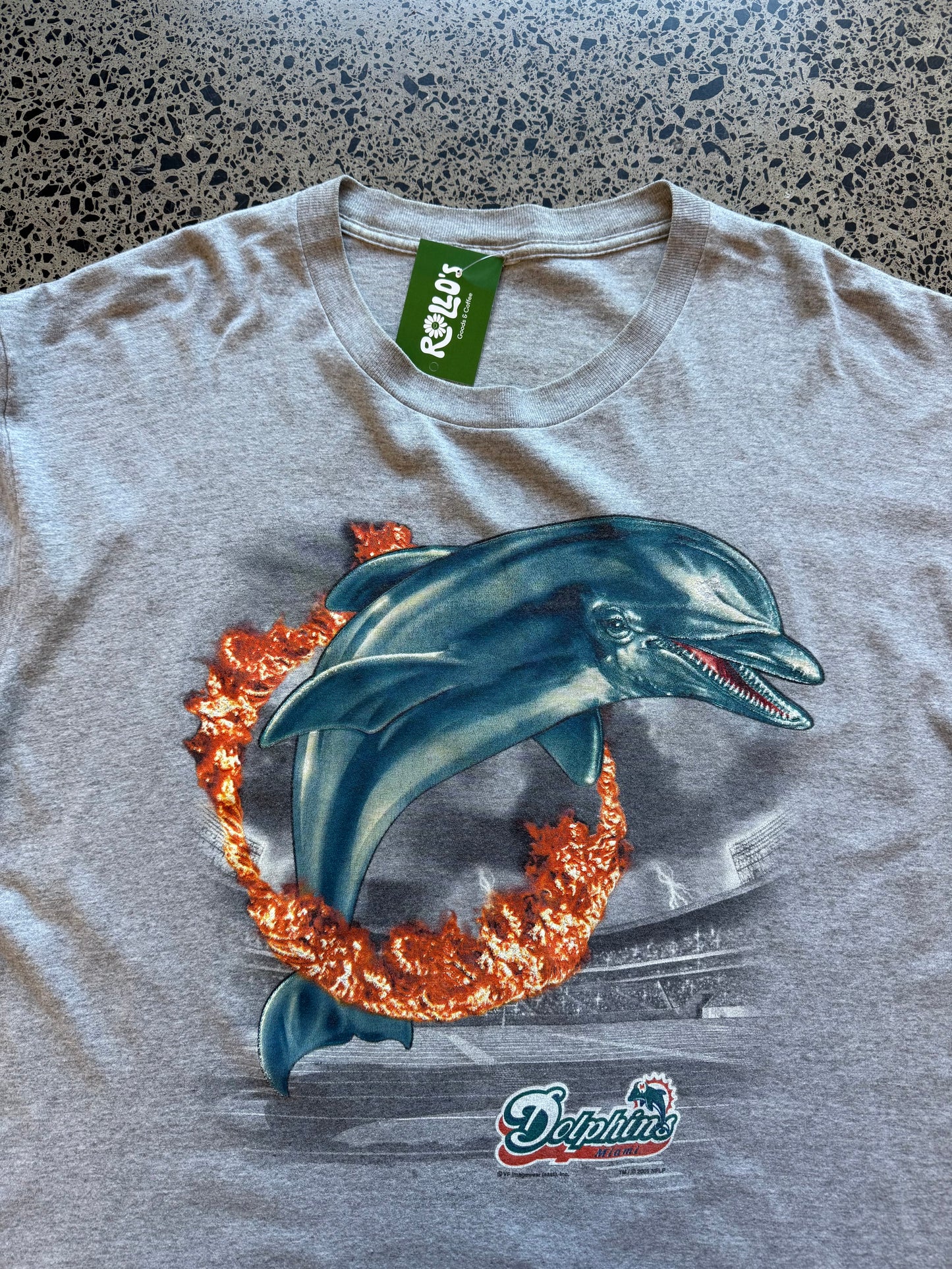 Grey 2001 Miami Dolphins NFL graphic t-shirt with teal and orange print, size XL, laid flat on a polished concrete background