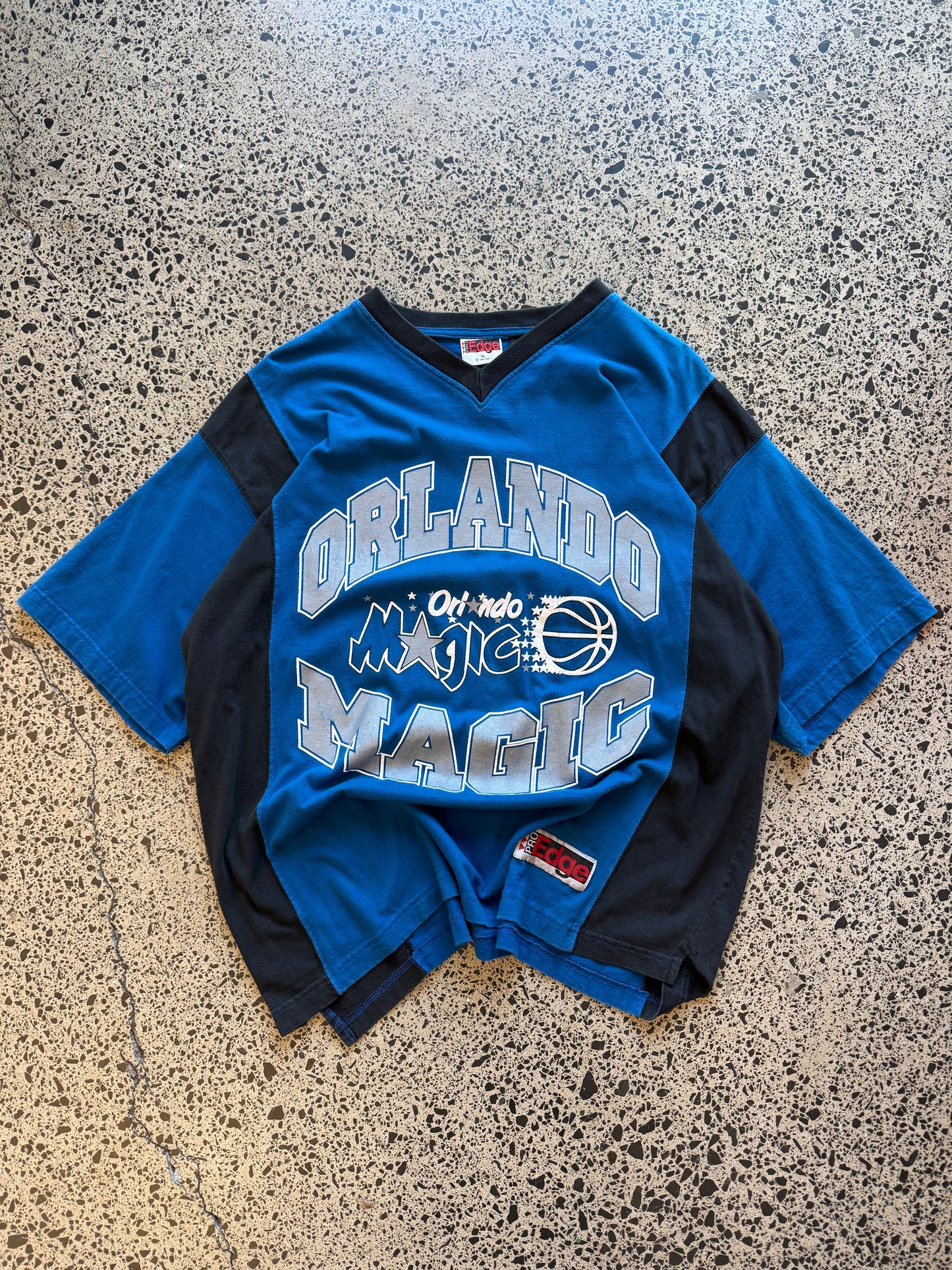 Vintage 90s NBA Orlando Magic black t-shirt with large front team logo graphic. Size XL. Basketball memorabilia