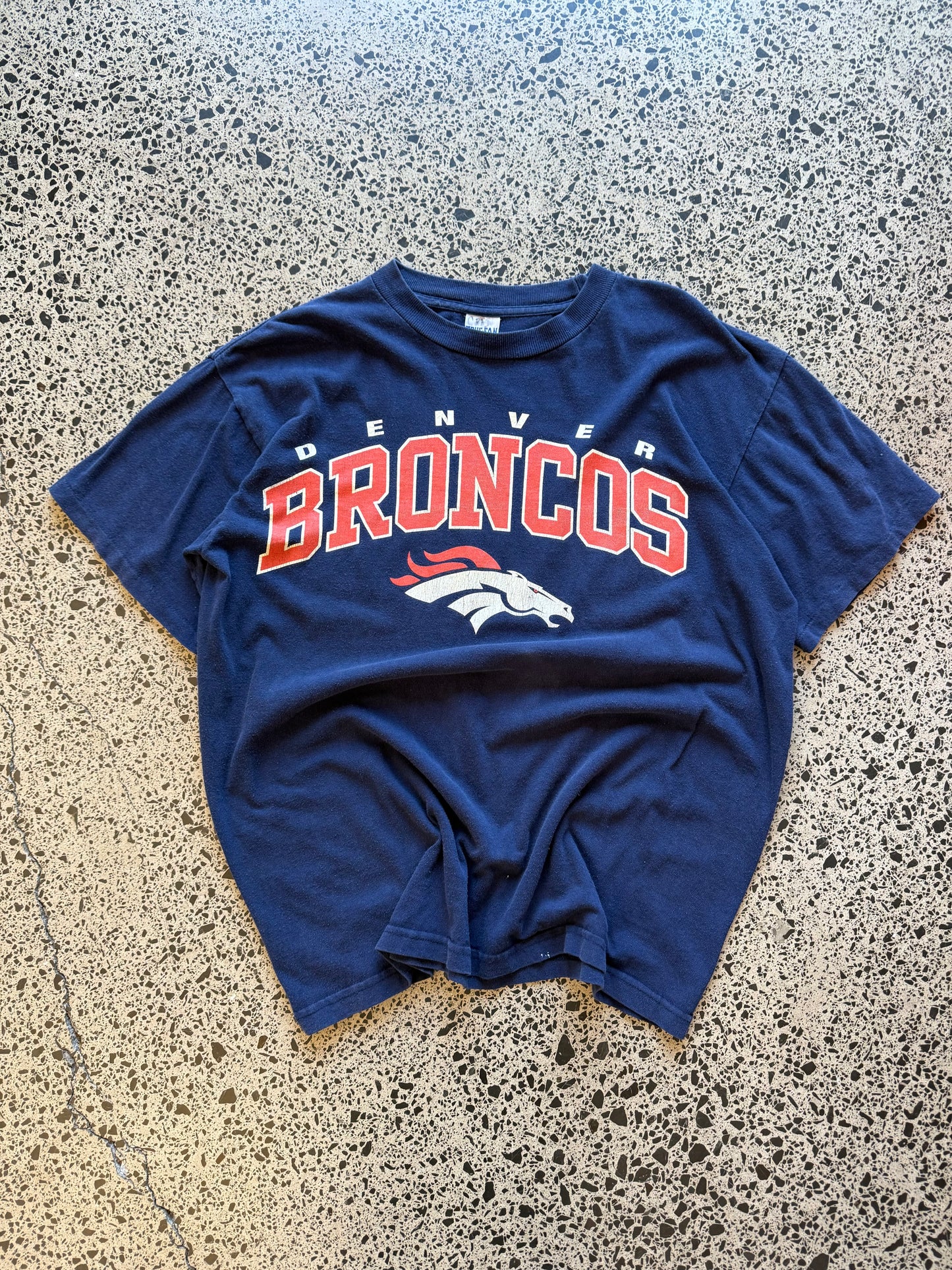Vintage 90s NFL Denver Broncos navy t-shirt with bold orange and blue team graphic. Size XL. Football memorabilia