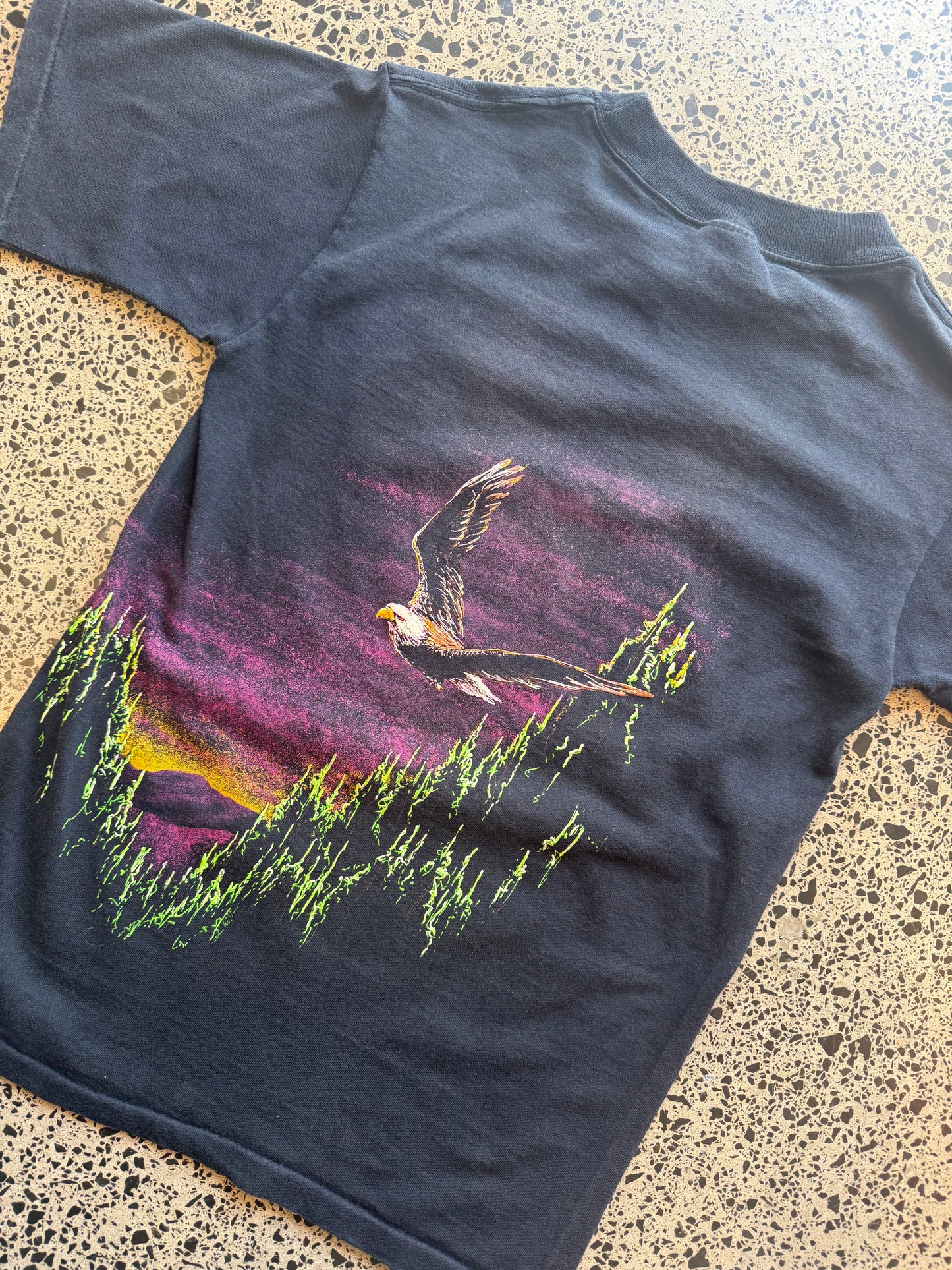 90s eagle graphic T-shirt, size S, laid on polished concrete background — vintage Americana eagle print on soft cotton.