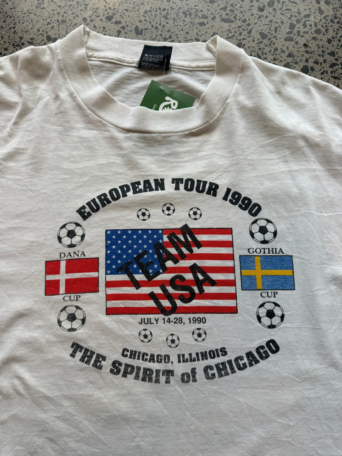 1990s Team USA European Football Tour T-shirt, size XL, laid on polished concrete background, bold vintage tour graphic on soft cotton.
