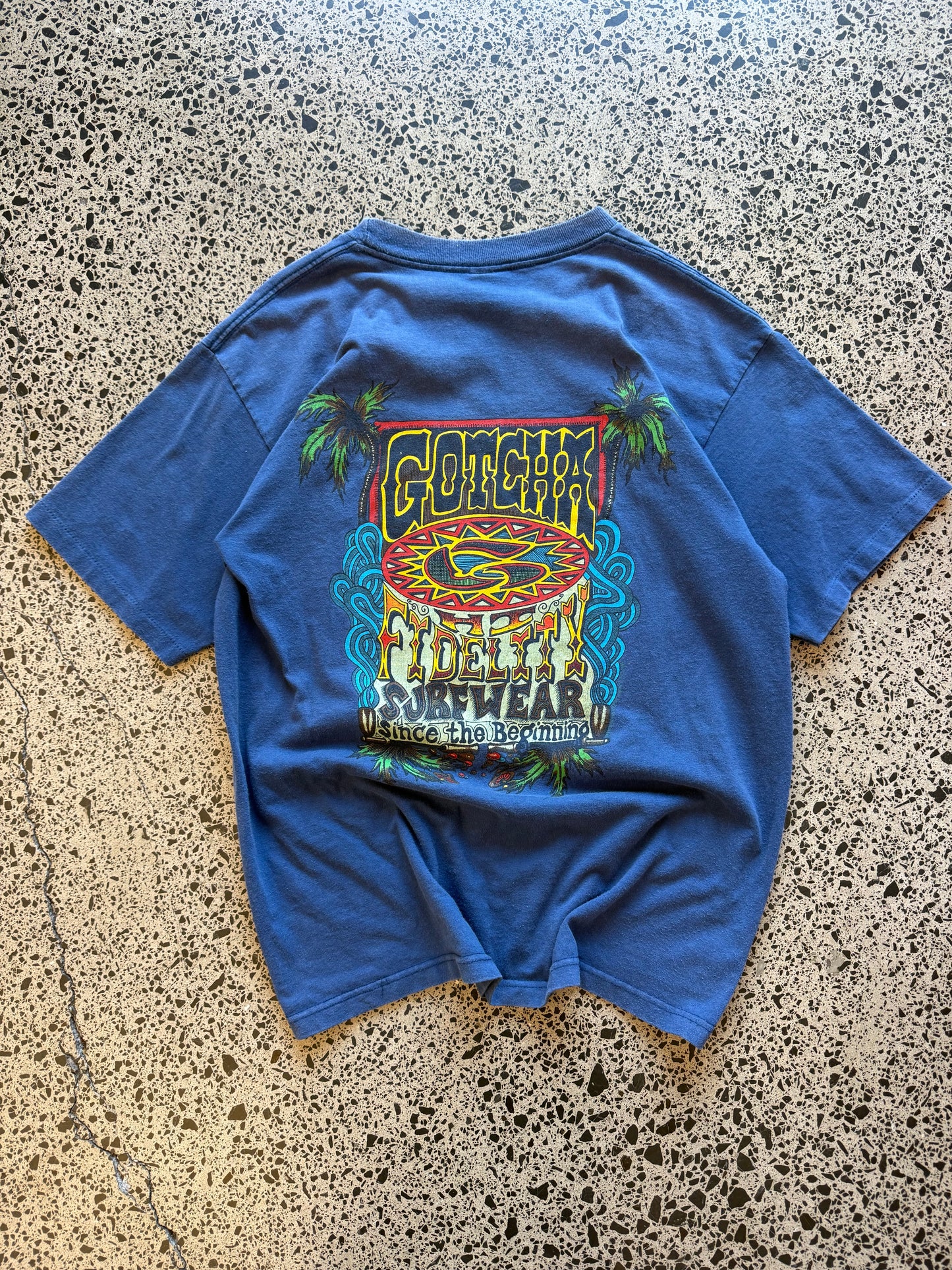 Vintage 90s Gotcha Surf blue t-shirt with bold colourful back graphic and subtle chest logo. Size L. Classic surfwear