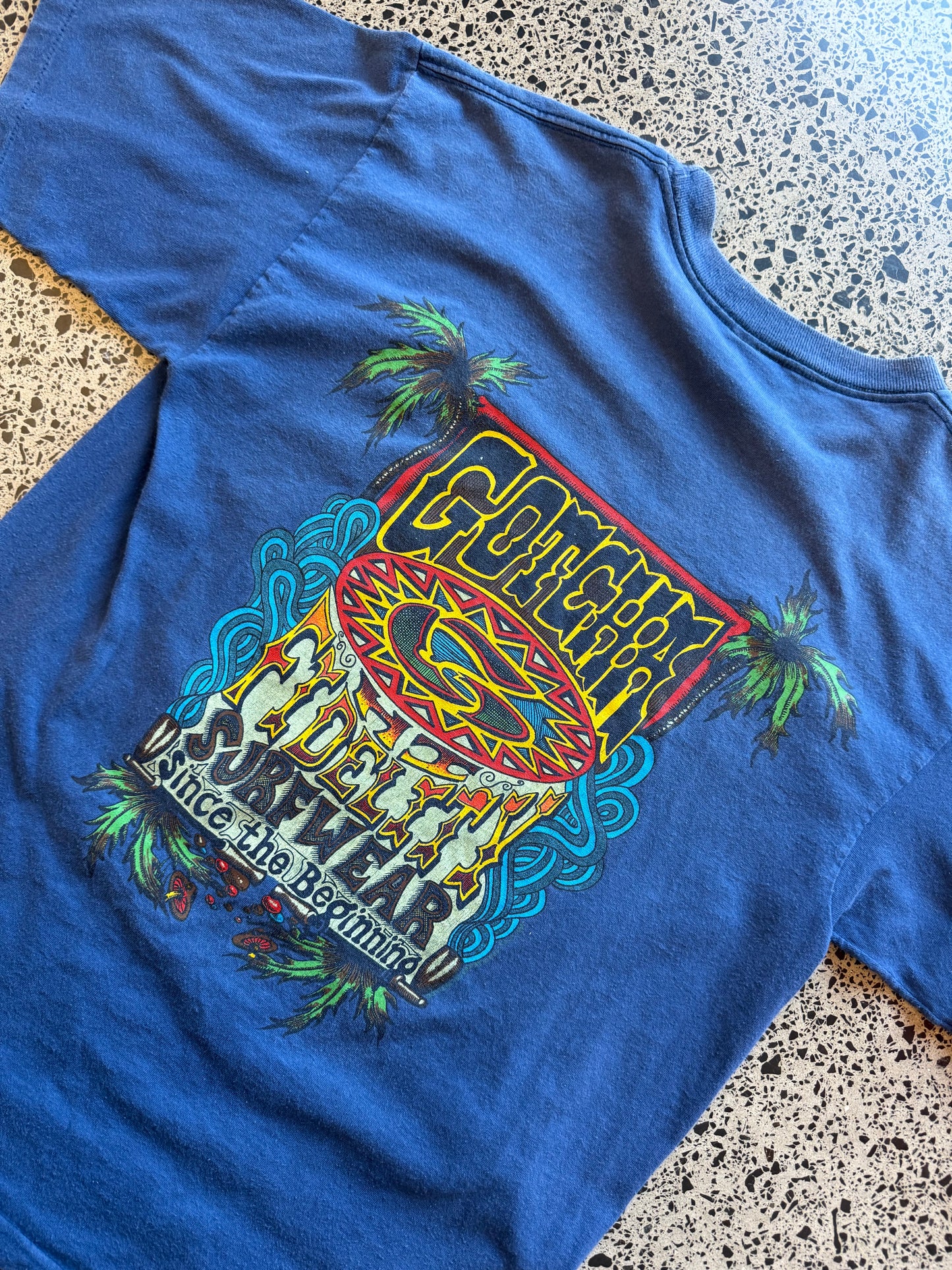 Vintage 90s Gotcha Surf blue t-shirt with bold colourful back graphic and subtle chest logo. Size L. Classic surfwear