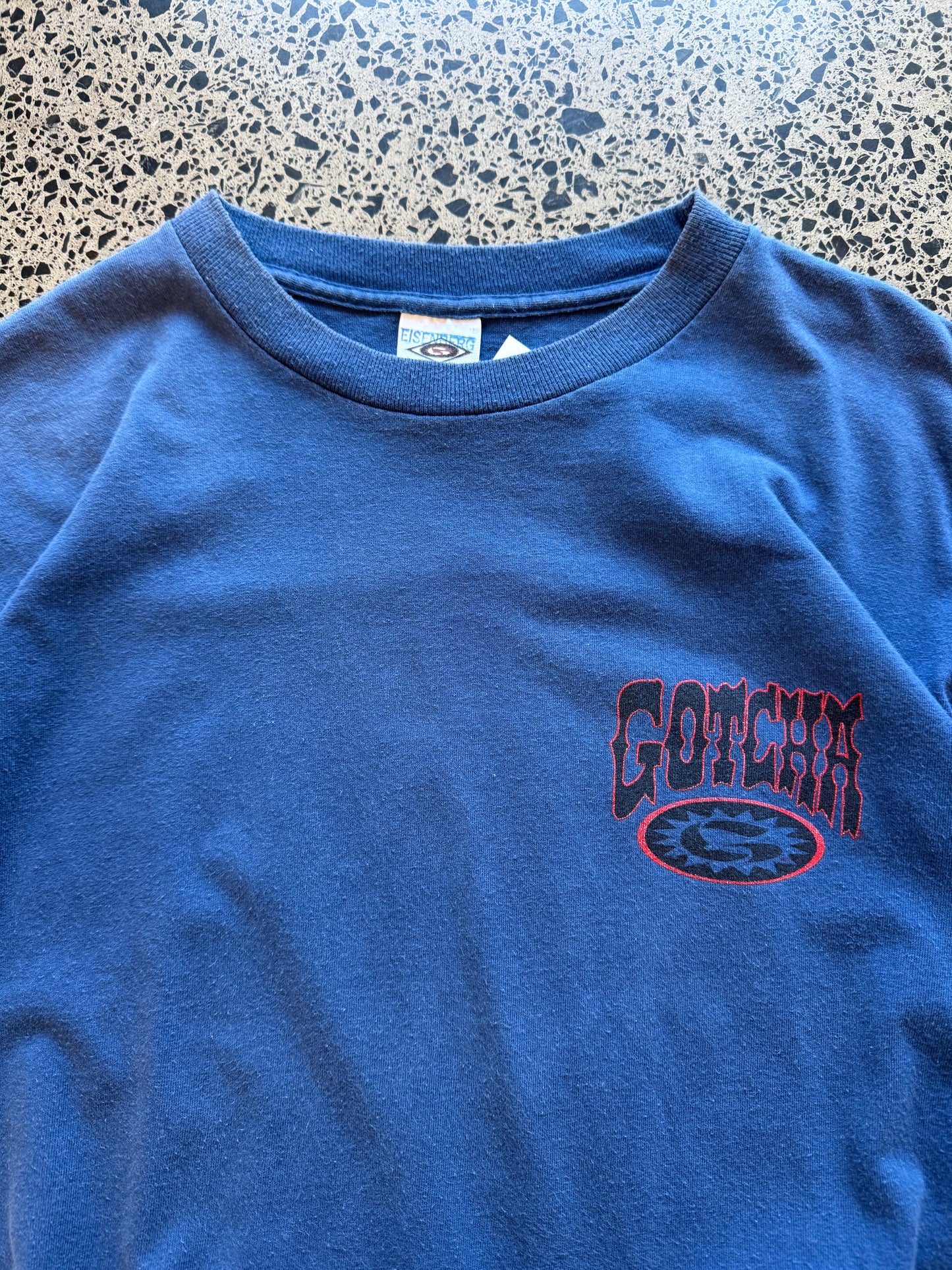 Vintage 90s Gotcha Surf blue t-shirt with bold colourful back graphic and subtle chest logo. Size L. Classic surfwear