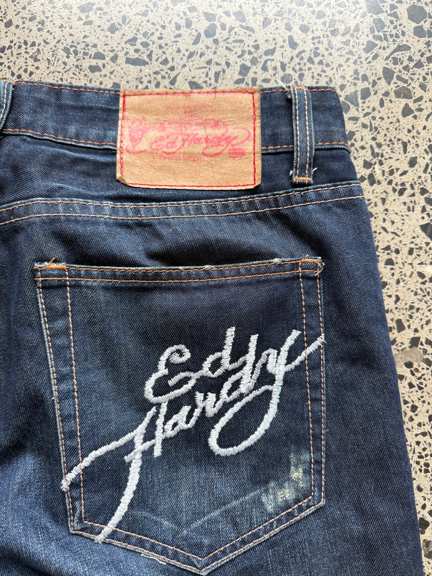 Y2K Ed Hardy embroidered dark blue jeans with devil joker playing card graphics. Size W32 L33.
