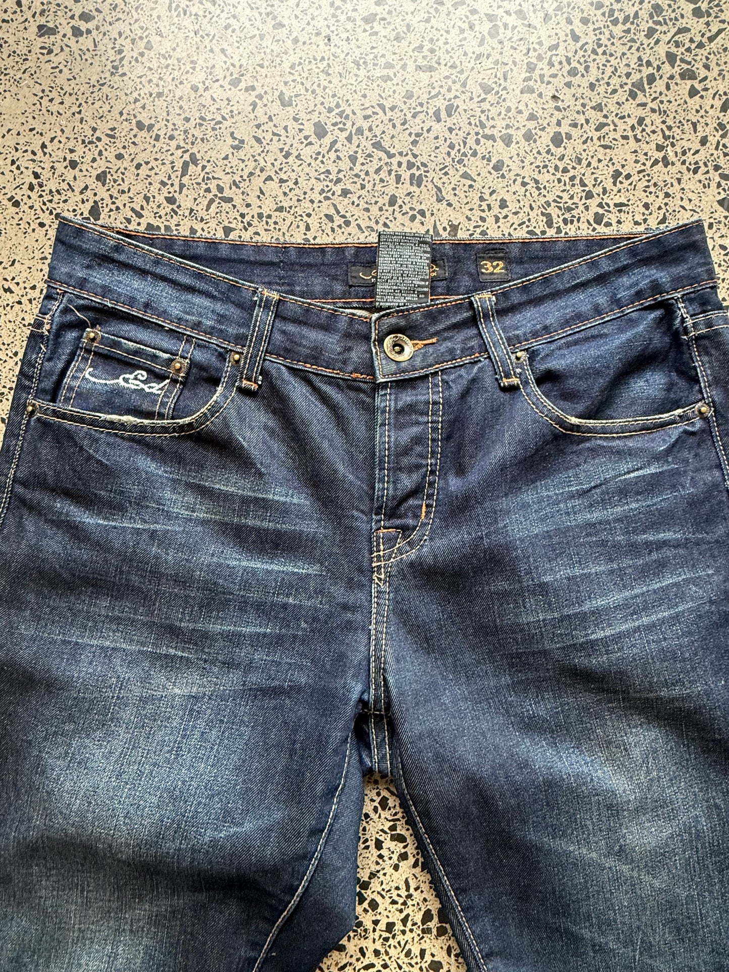 Y2K Ed Hardy embroidered dark blue jeans with devil joker playing card graphics. Size W32 L33.