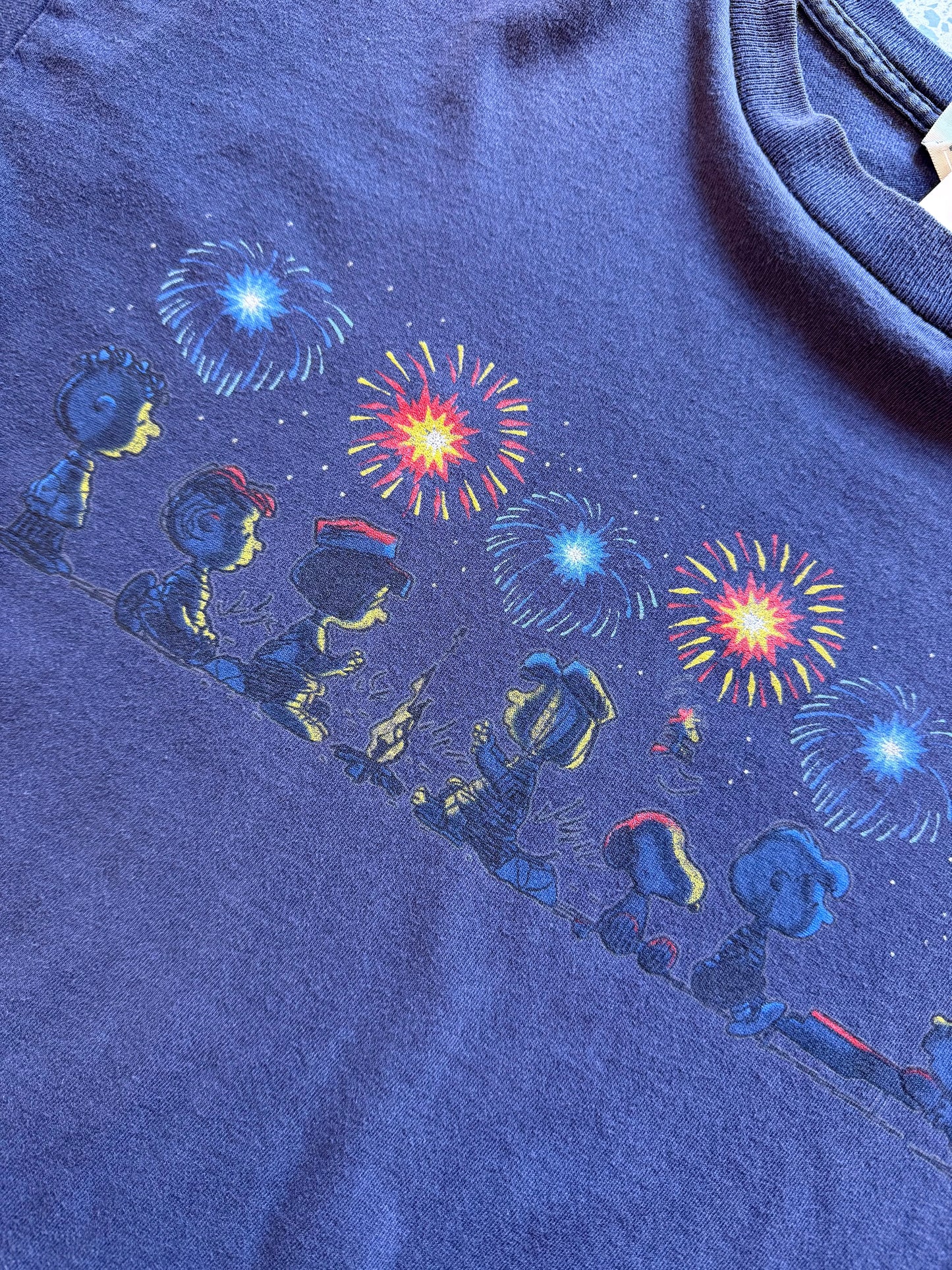 Vintage Y2K Peanuts black t-shirt featuring bold, colourful Snoopy and friends graphic. Size XL. Nostalgic comic strip tee