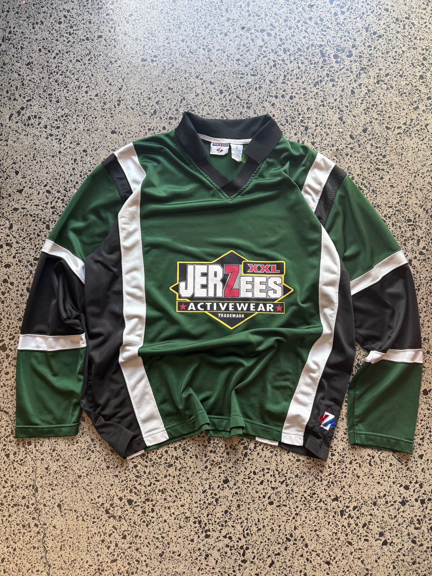 Front view of vintage 90s Jerzees NHL-style black, red, and white sports jersey in XL, laid flat on white background