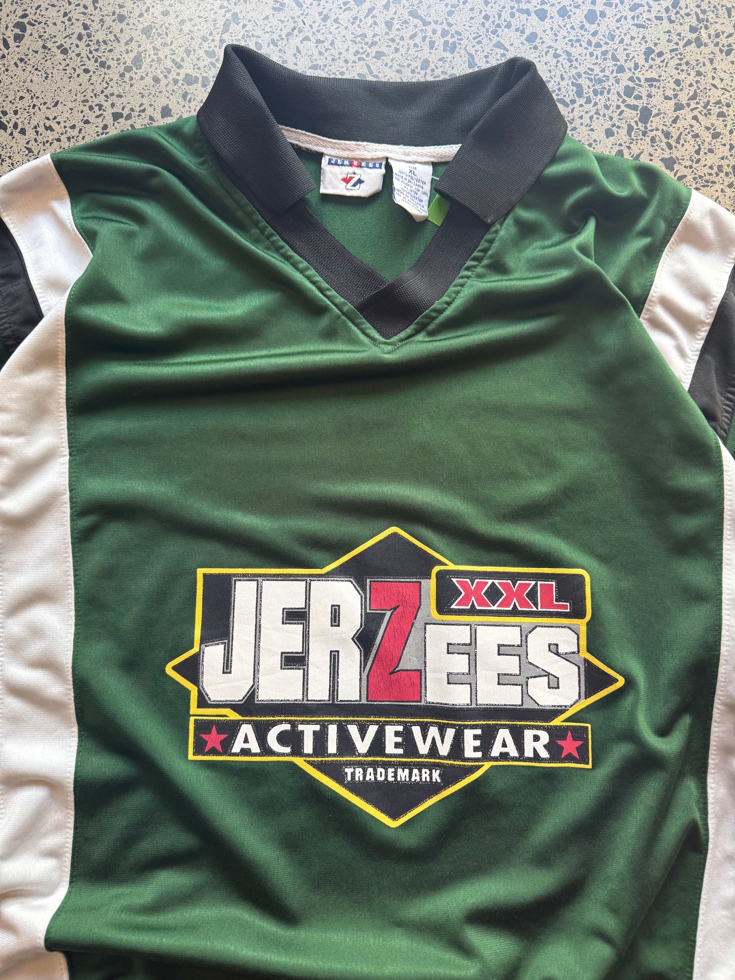 Front view of vintage 90s Jerzees NHL-style black, red, and white sports jersey in XL, laid flat on white background
