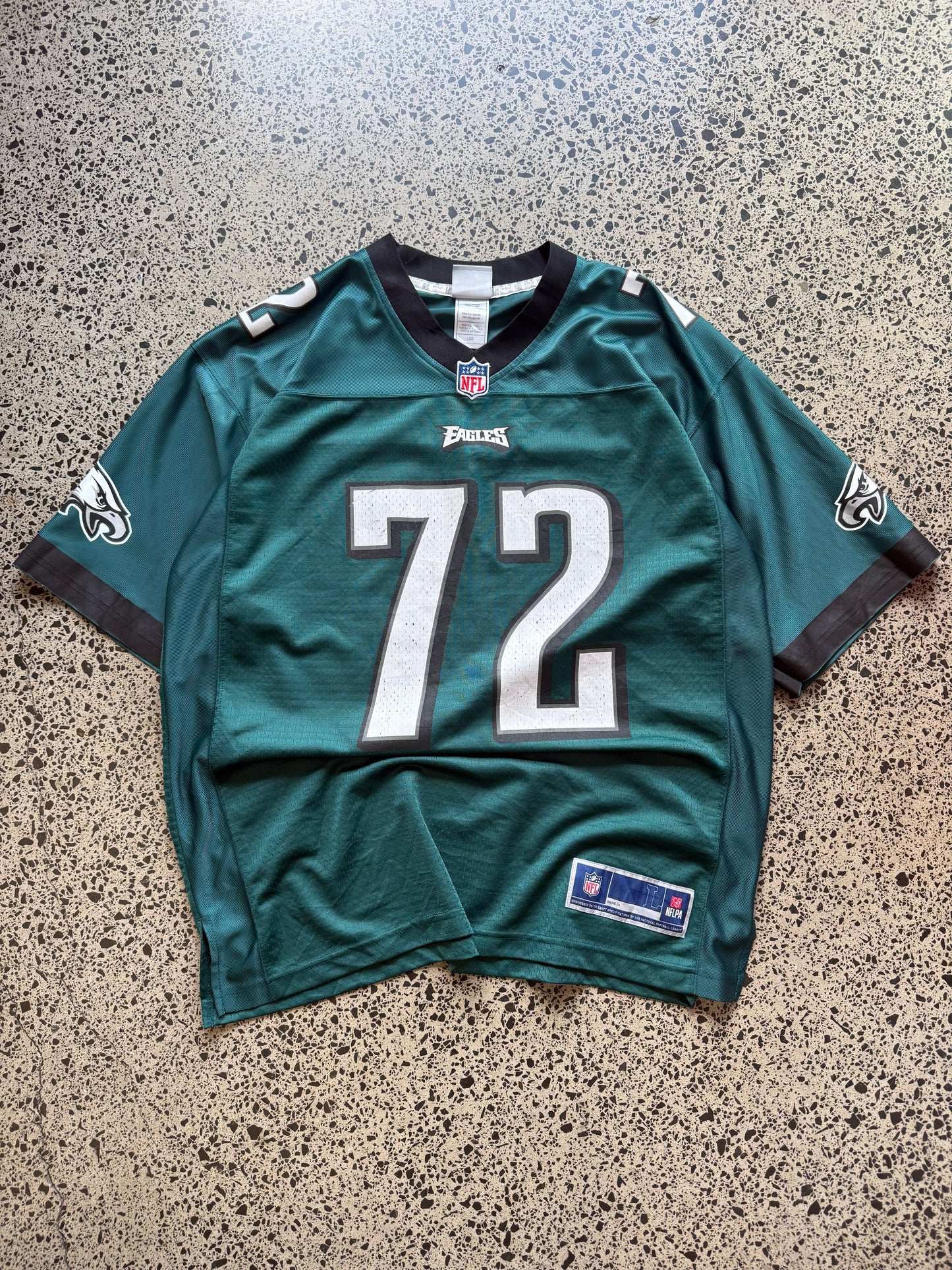 Philadelphia Eagles Halapoulivaati Vaitai NFL jersey size L laid on polished concrete background — midnight green with white detailing and Eagles logo.