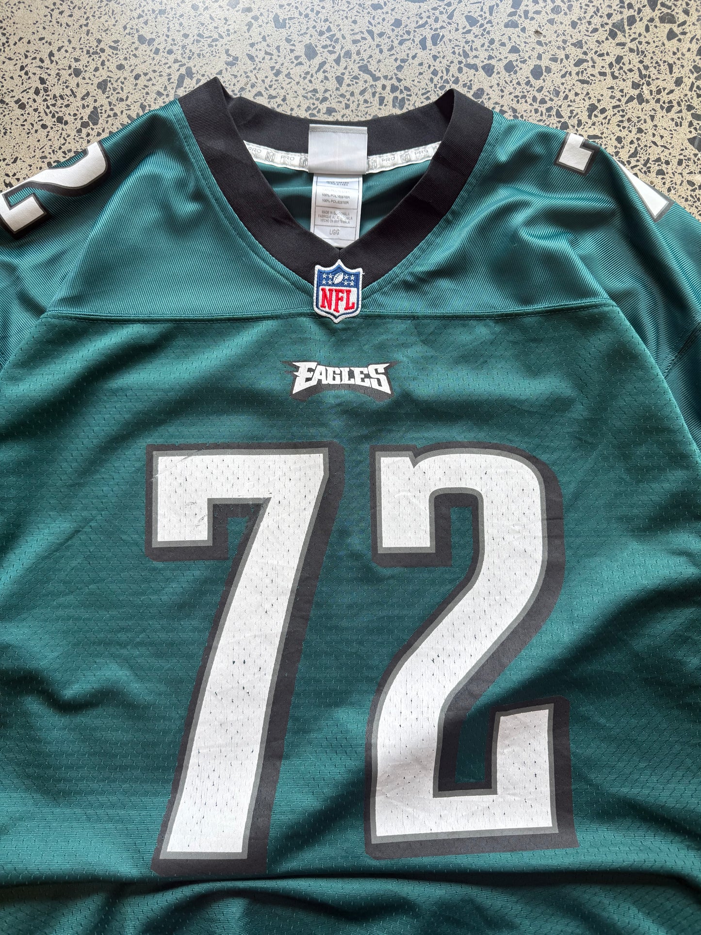 Philadelphia Eagles Halapoulivaati Vaitai NFL jersey size L laid on polished concrete background — midnight green with white detailing and Eagles logo.