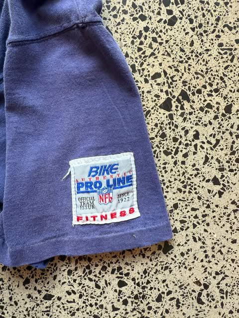 1993 Dallas Cowboys NFL T-shirt in size XL laid on a polished concrete background — vintage early-90s football graphic on soft cotton.