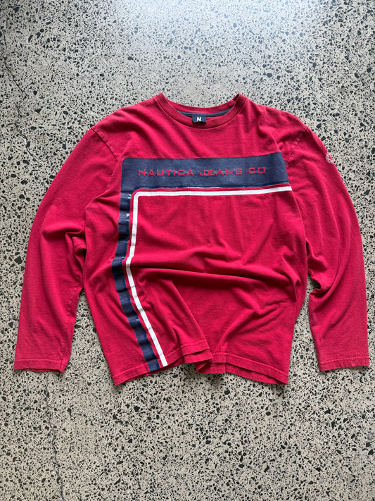 2000s Nautica long sleeve T-shirt, navy, size L, laid on polished concrete background — subtle Y2K branding on soft cotton.