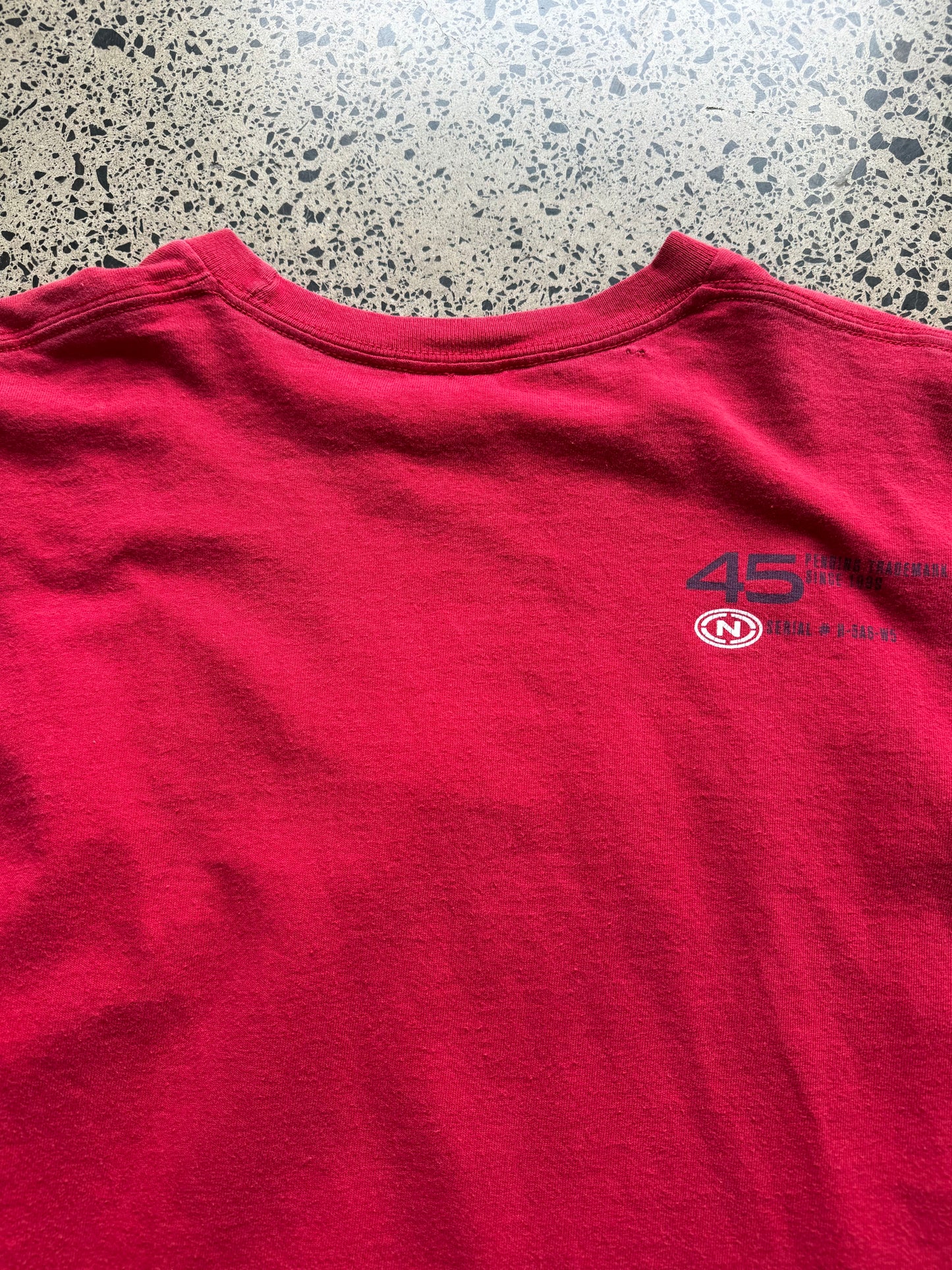 2000s Nautica long sleeve T-shirt, navy, size L, laid on polished concrete background — subtle Y2K branding on soft cotton.