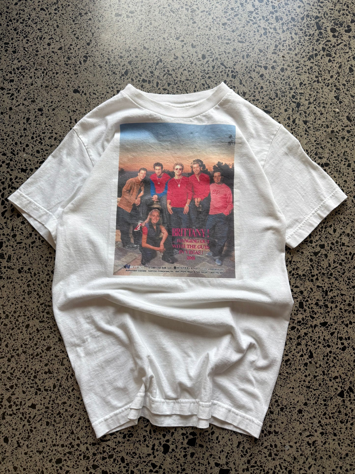 2001 *NSYNC and Britney Spears graphic T-shirt, size S, laid on polished concrete background — vintage Y2K pop-culture band tee.