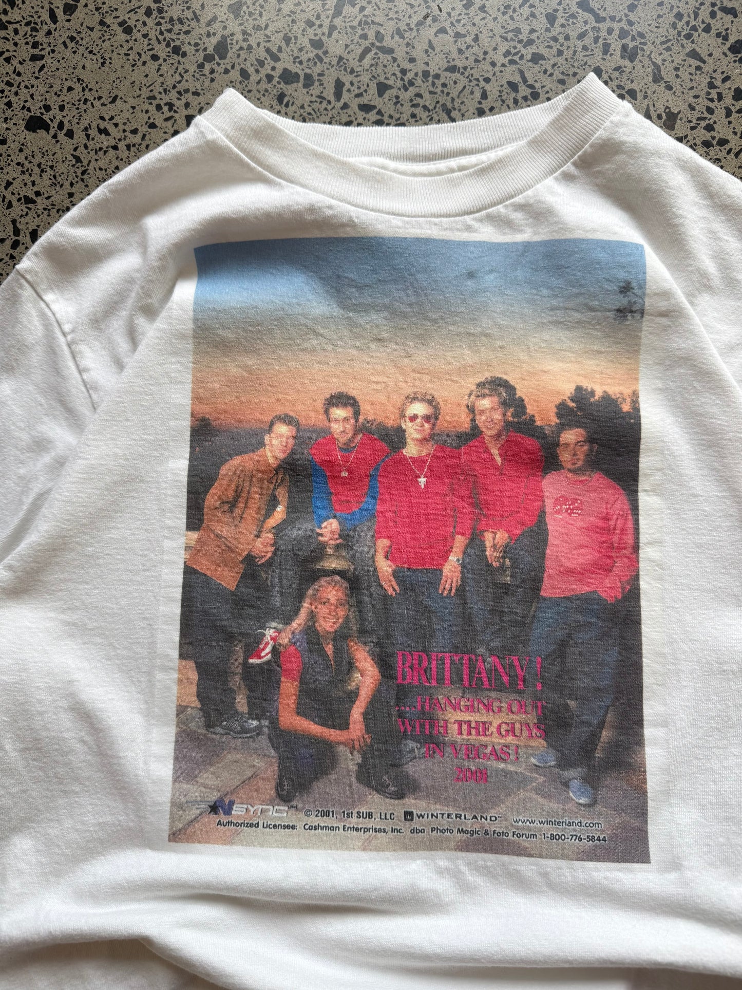 2001 *NSYNC and Britney Spears graphic T-shirt, size S, laid on polished concrete background — vintage Y2K pop-culture band tee.