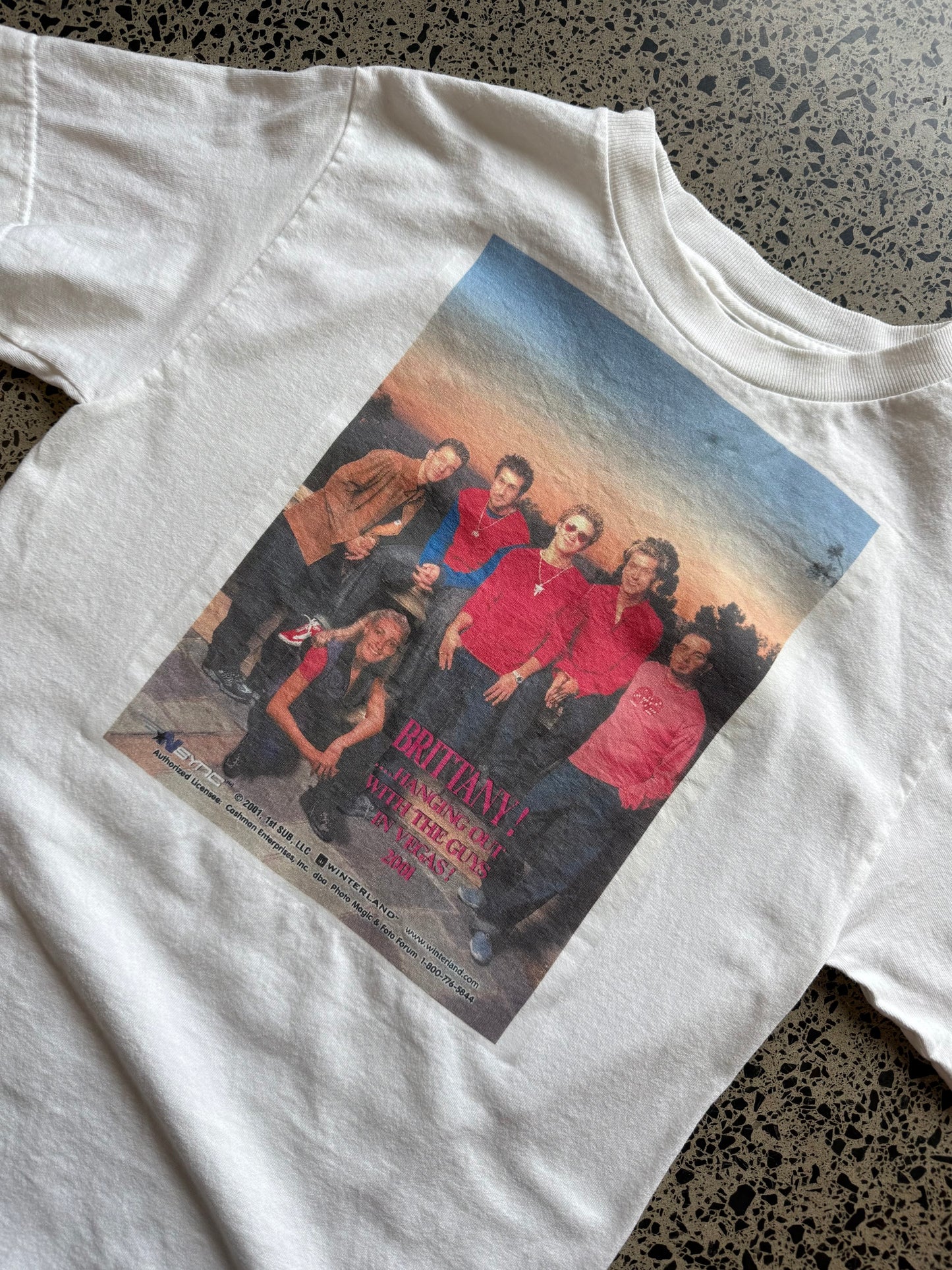 2001 *NSYNC and Britney Spears graphic T-shirt, size S, laid on polished concrete background — vintage Y2K pop-culture band tee.