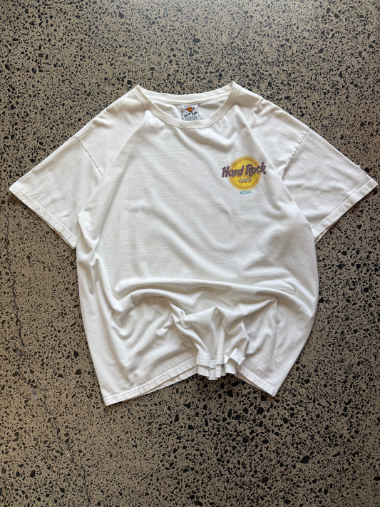 White 80s Hard Rock Kona graphic t-shirt with multicoloured print, size XL, laid flat on a polished concrete background