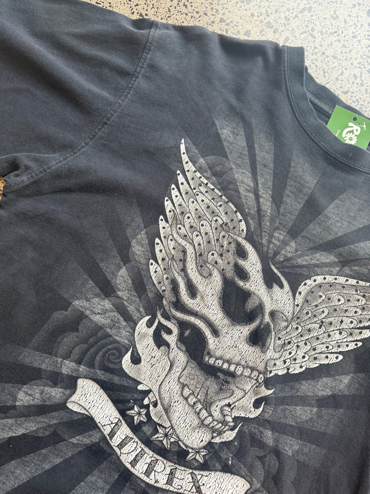 Black Affliction t-shirt with large winged skull graphic on front, size XL, laid flat on white background