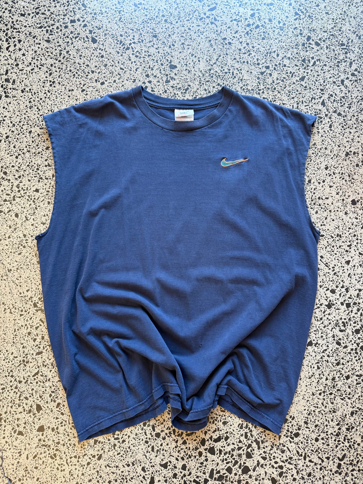 Vintage 90s Nike navy singlet with embroidered white swoosh logo. Size XL. Athletic streetwear.