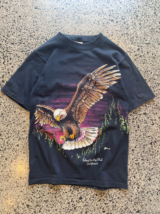 90s eagle graphic T-shirt, size S, laid on polished concrete background — vintage Americana eagle print on soft cotton.