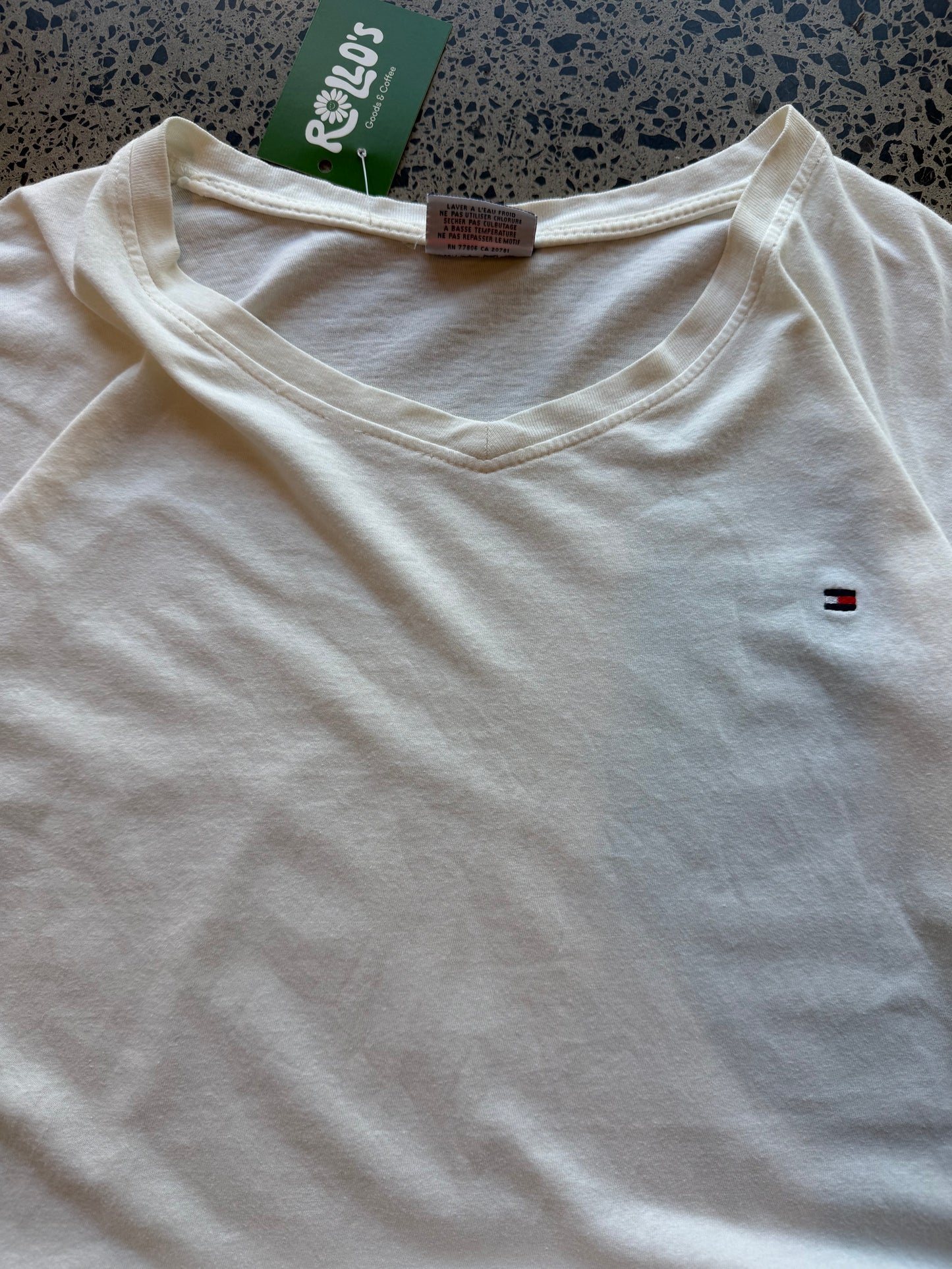 Tommy Hilfiger blank T-shirt, size 2XL, laid on polished concrete background — minimal design on soft cotton tee.