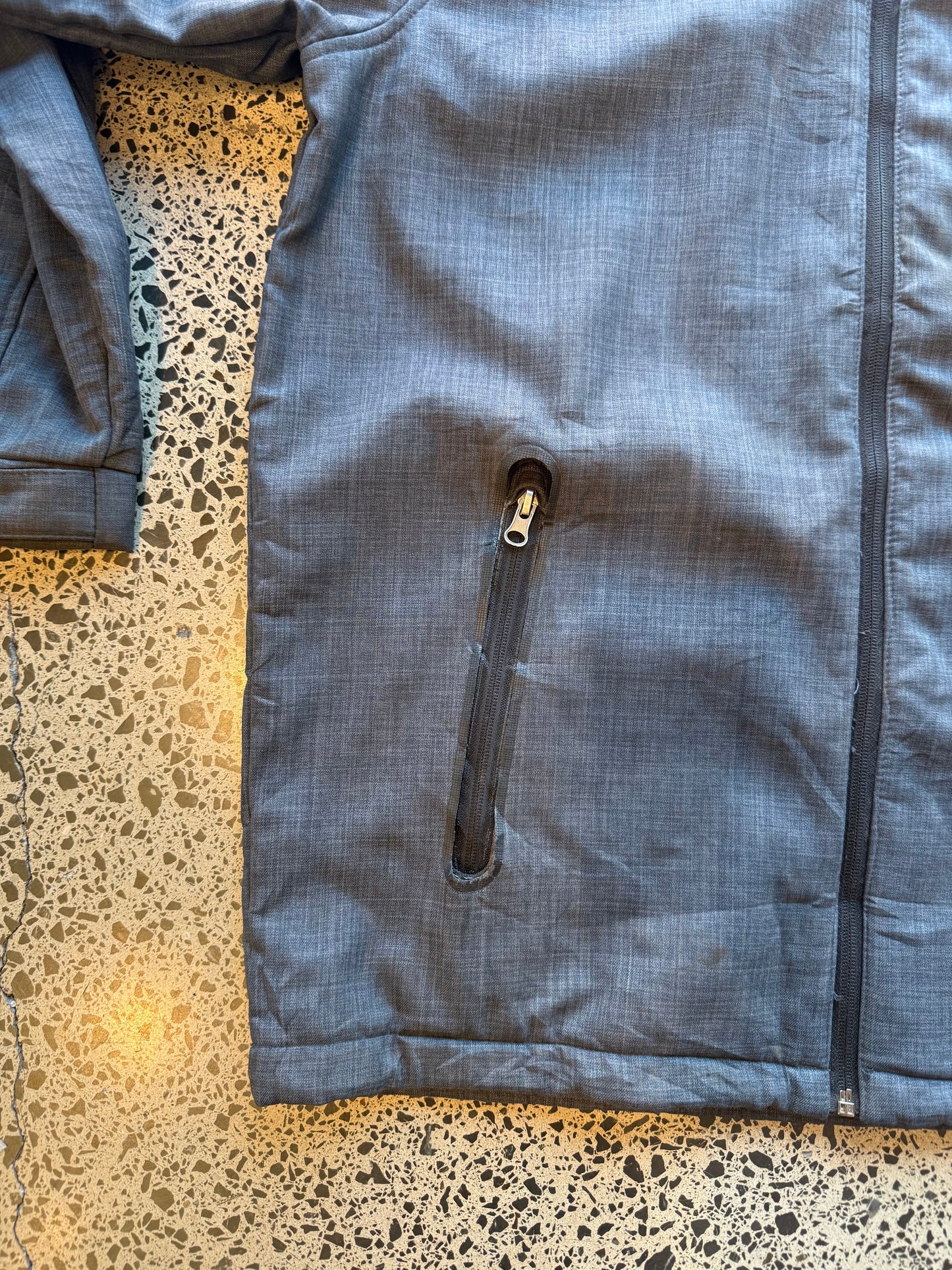 Seattle Seahawks NFL soft shell jacket size M laid flat on polished concrete background, lightweight sportswear jacket with subtle team branding and clean fit.
