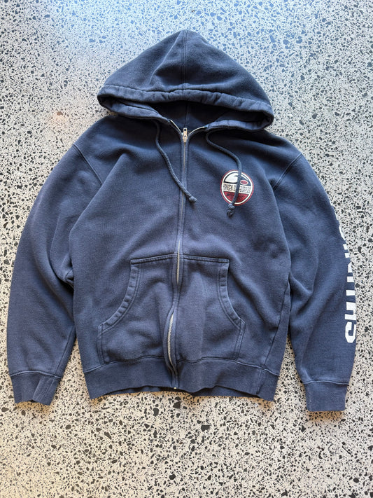 Hansen Surfboards California zip-up hoodie size M laid flat on polished concrete background, surfwear hoodie with minimal branding and relaxed fit.