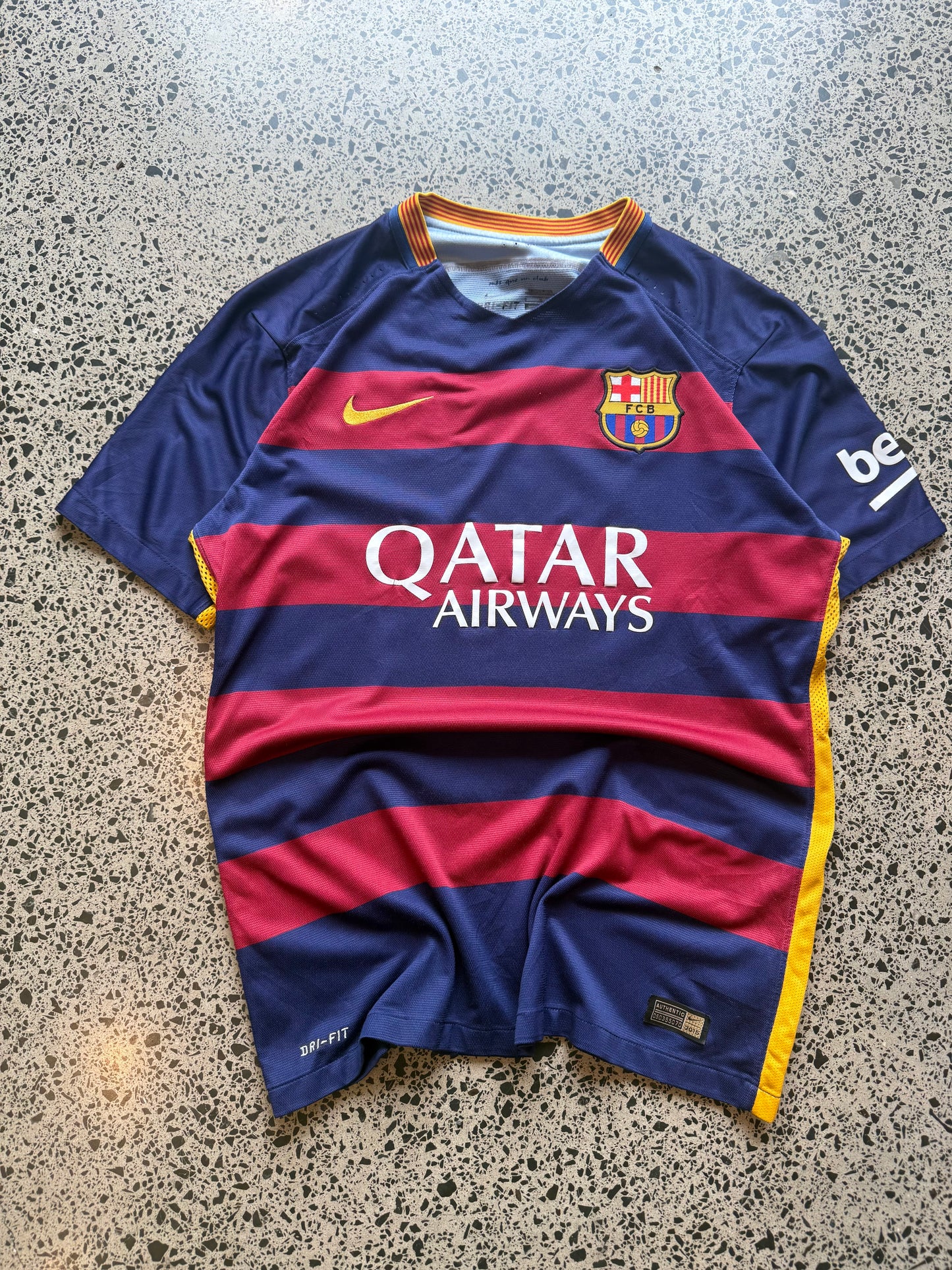 2015/16 FC Barcelona player issue football jersey in size L laid flat on a polished concrete background featuring the classic blue and red stripes.