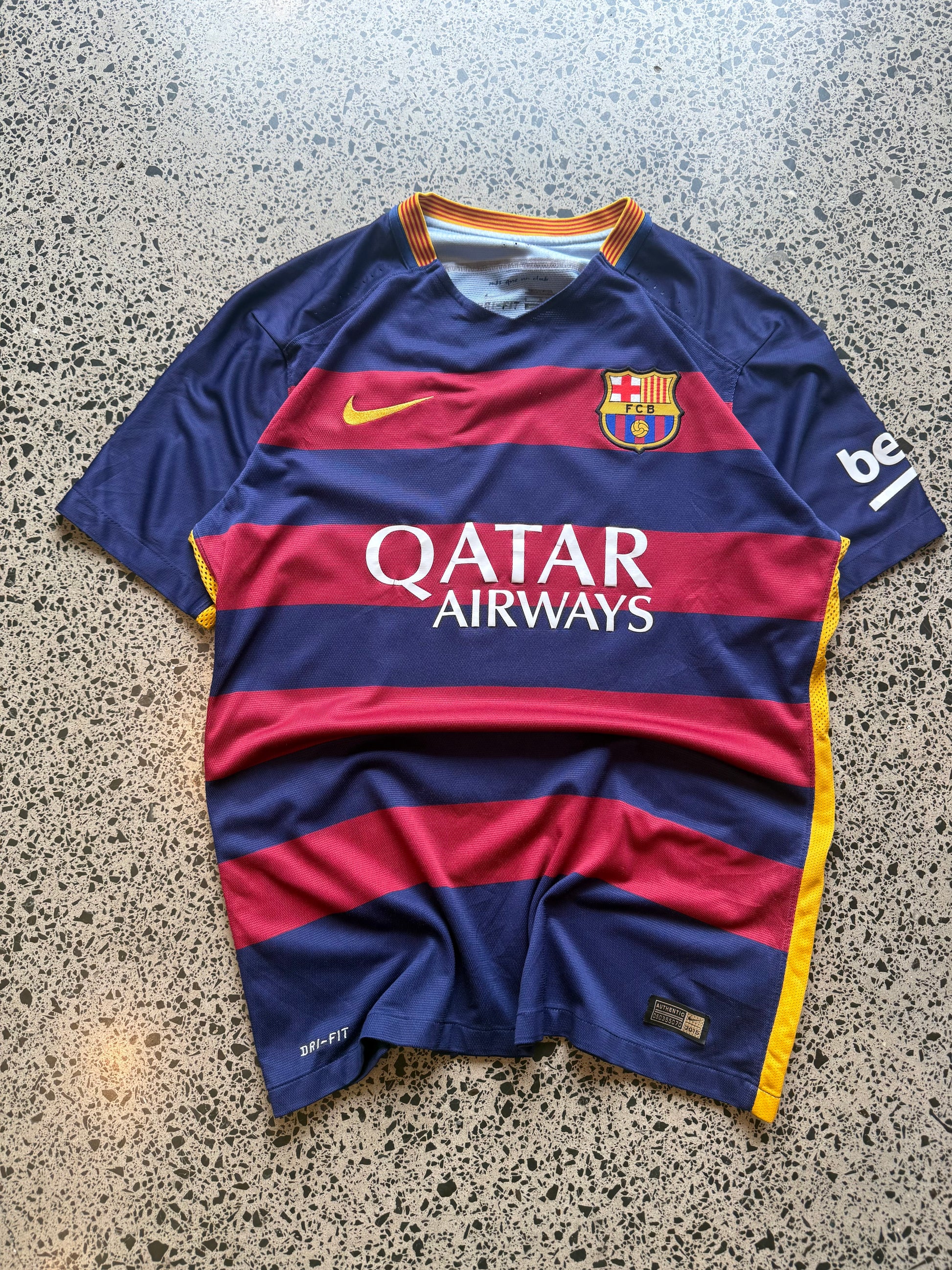 2015/16 FC Barcelona player issue football jersey in size L laid flat on a polished concrete background featuring the classic blue and red stripes.