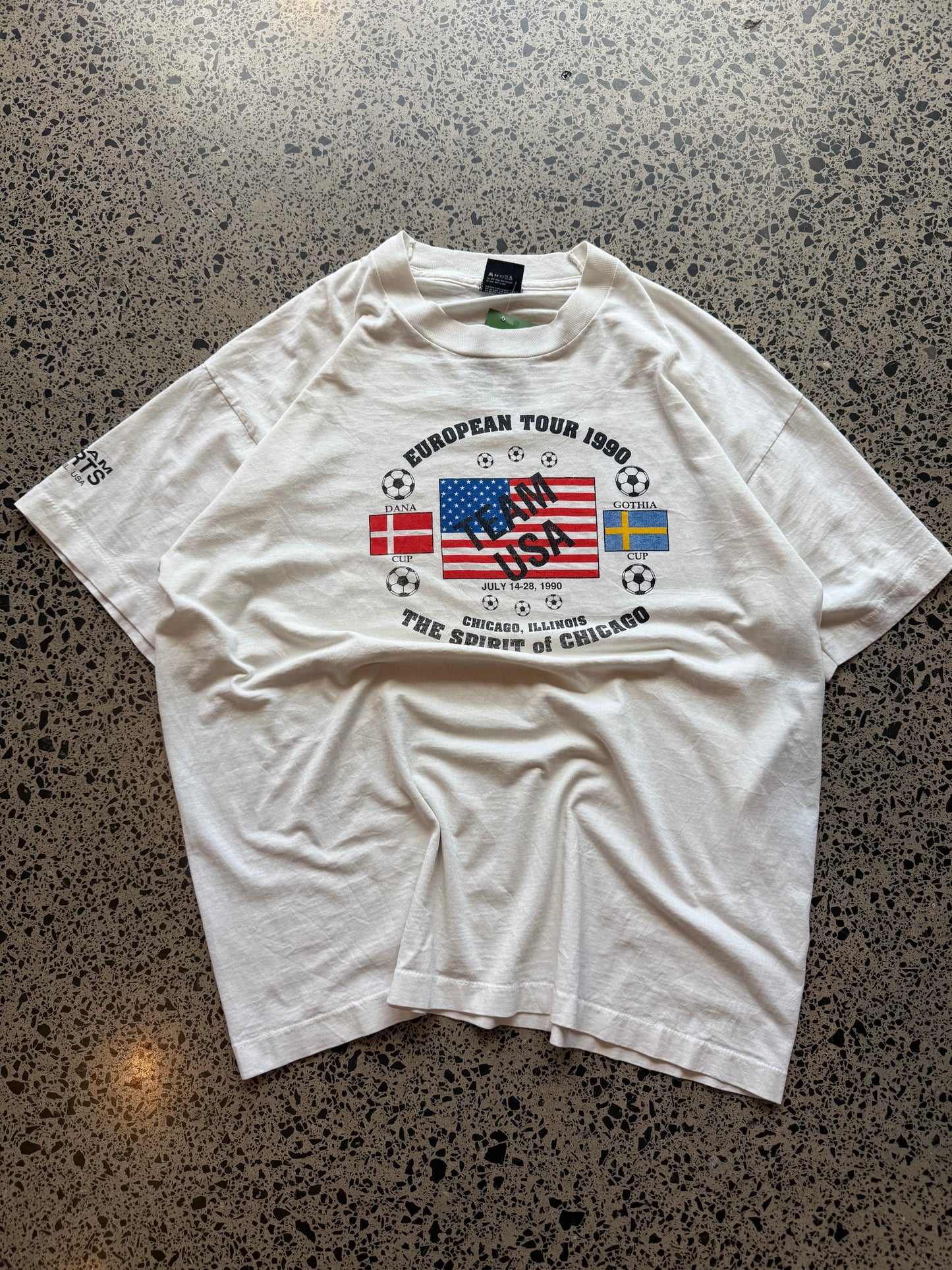 1990s Team USA European Football Tour T-shirt, size XL, laid on polished concrete background, bold vintage tour graphic on soft cotton.