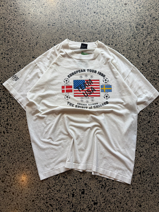 1990s Team USA European Football Tour T-shirt, size XL, laid on polished concrete background, bold vintage tour graphic on soft cotton.