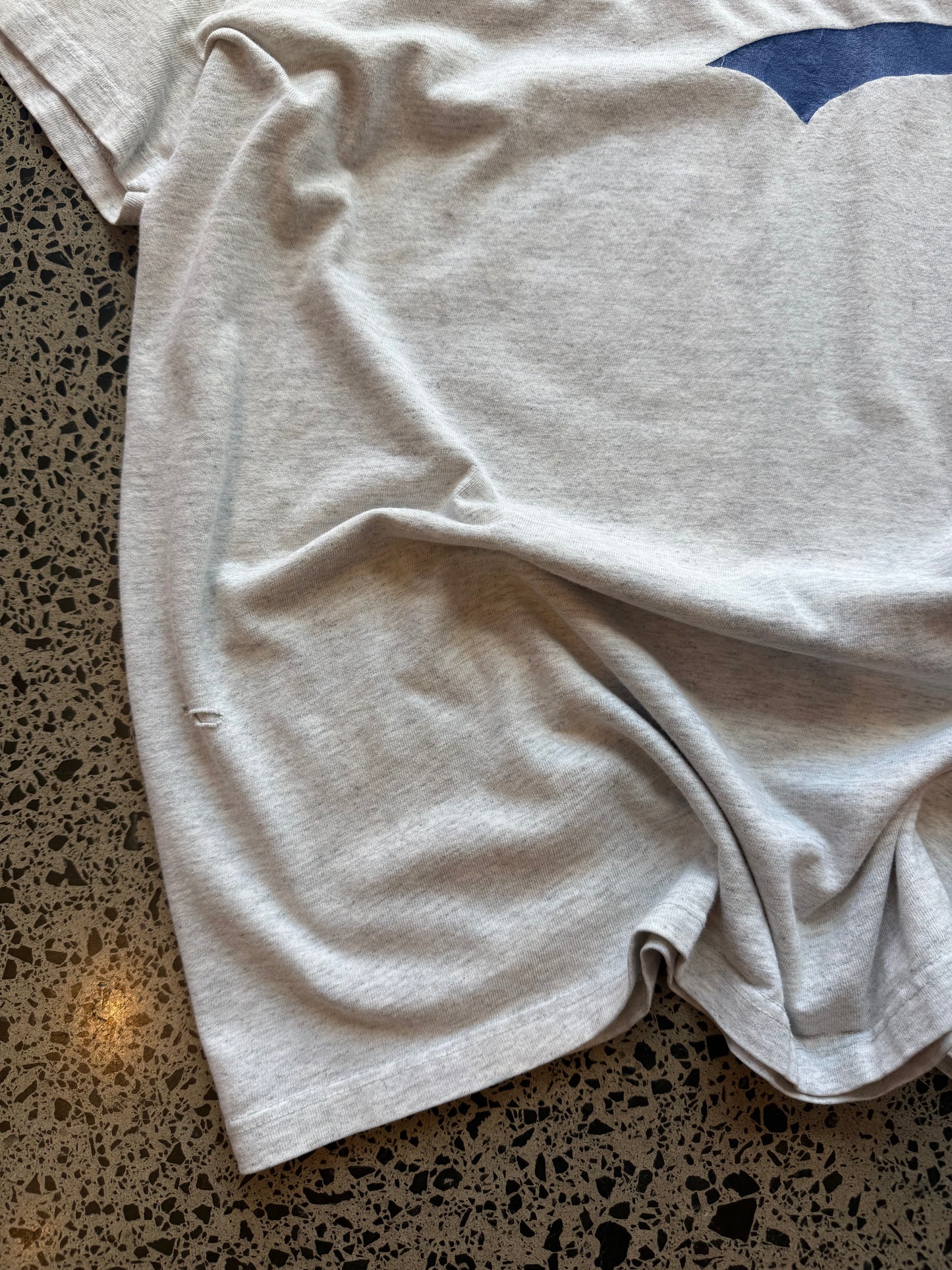 90s grey Brooklyn graphic T-shirt, size 2XL, laid on polished concrete background soft vintage cotton with bold NYC lettering.