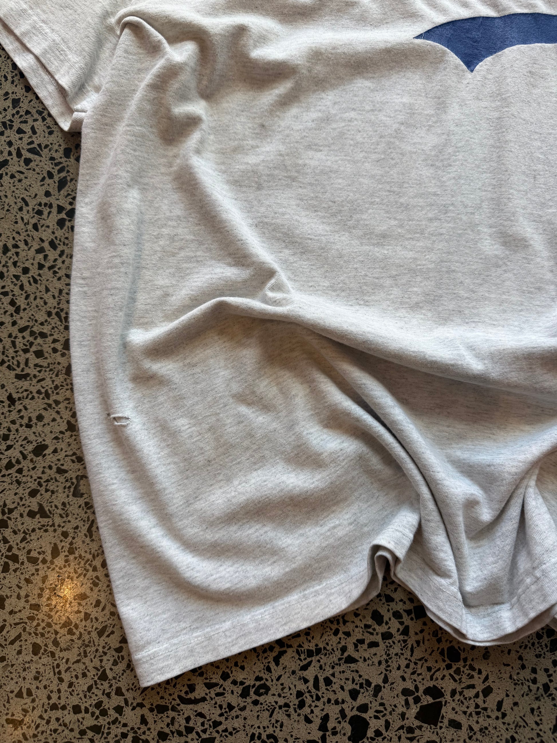 90s grey Brooklyn graphic T-shirt, size 2XL, laid on polished concrete background soft vintage cotton with bold NYC lettering.