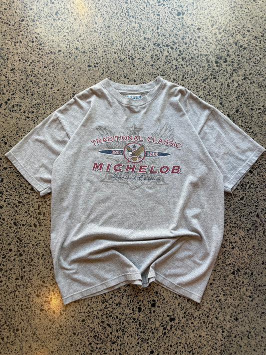 Traditional Michelob Lager graphic T-shirt, size L, laid on polished concrete background, vintage beer logo on soft cotton.