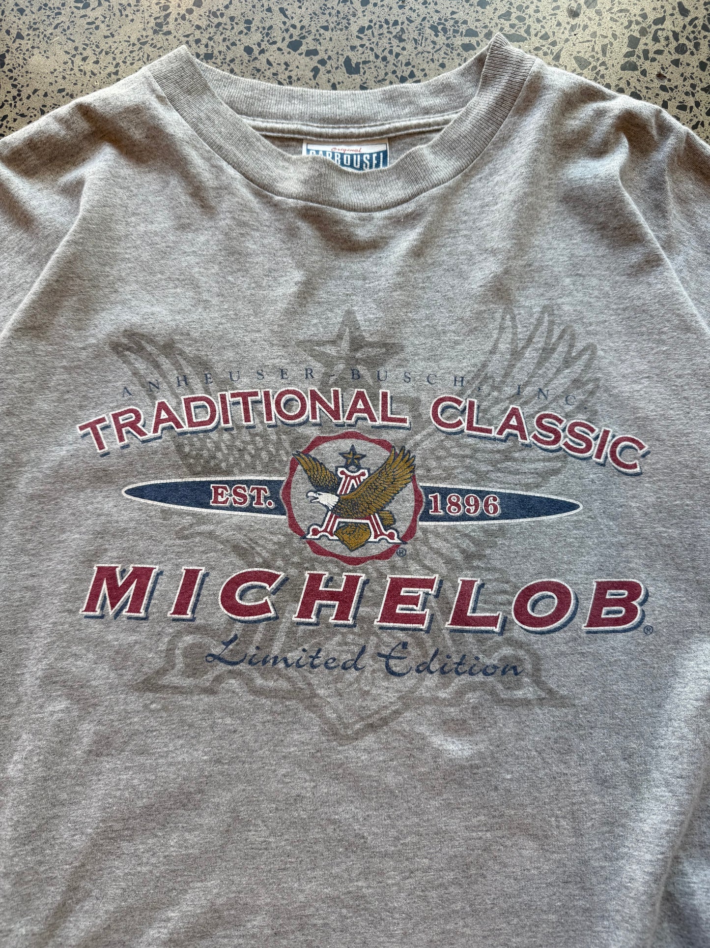 Traditional Michelob Lager graphic T-shirt, size L, laid on polished concrete background, vintage beer logo on soft cotton.