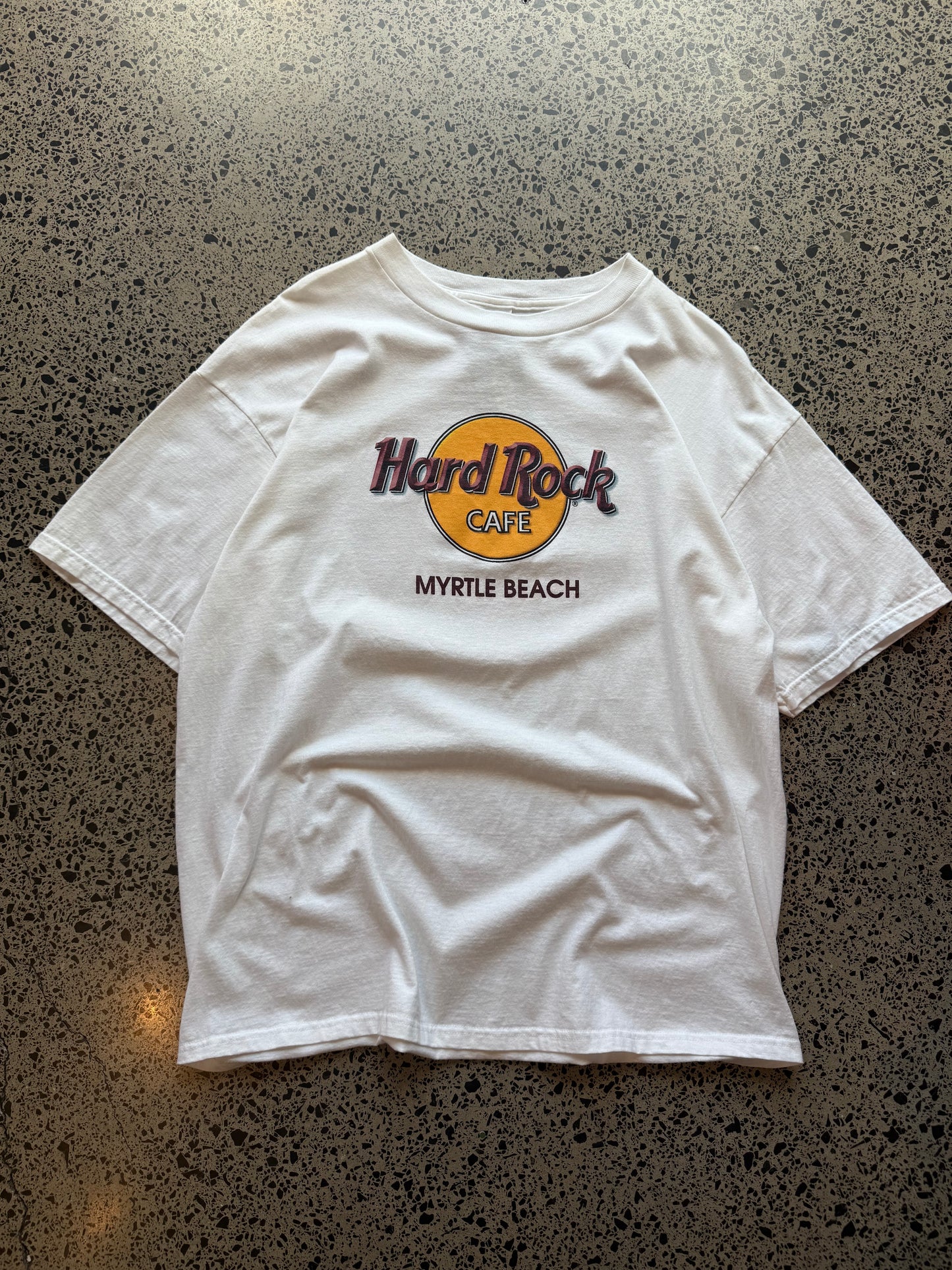 90s Myrtle Beach Hard Rock T-shirt, size XL, laid on polished concrete background vintage Hard Rock logo on soft 90s cotton.