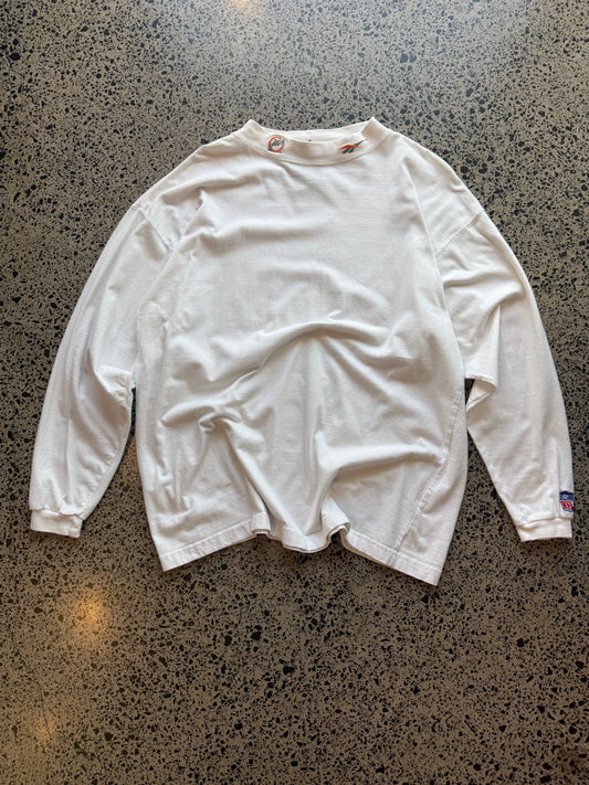 90s Miami Dolphins NFL long sleeve shirt 2XL laid flat on polished concrete background, vintage football tee with team colors and bold graphics.