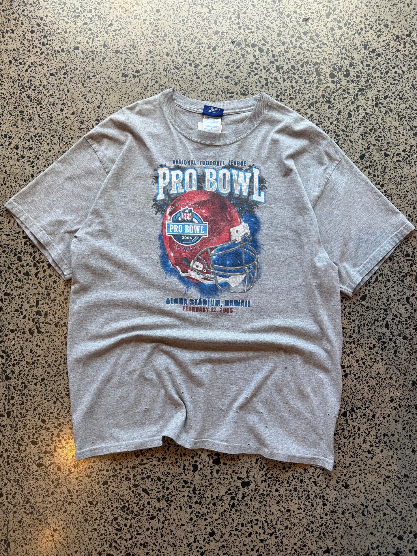 2006 Pro Bowl NFL T-shirt, size XL, laid on polished concrete background — bold mid-2000s football graphic on soft cotton.
