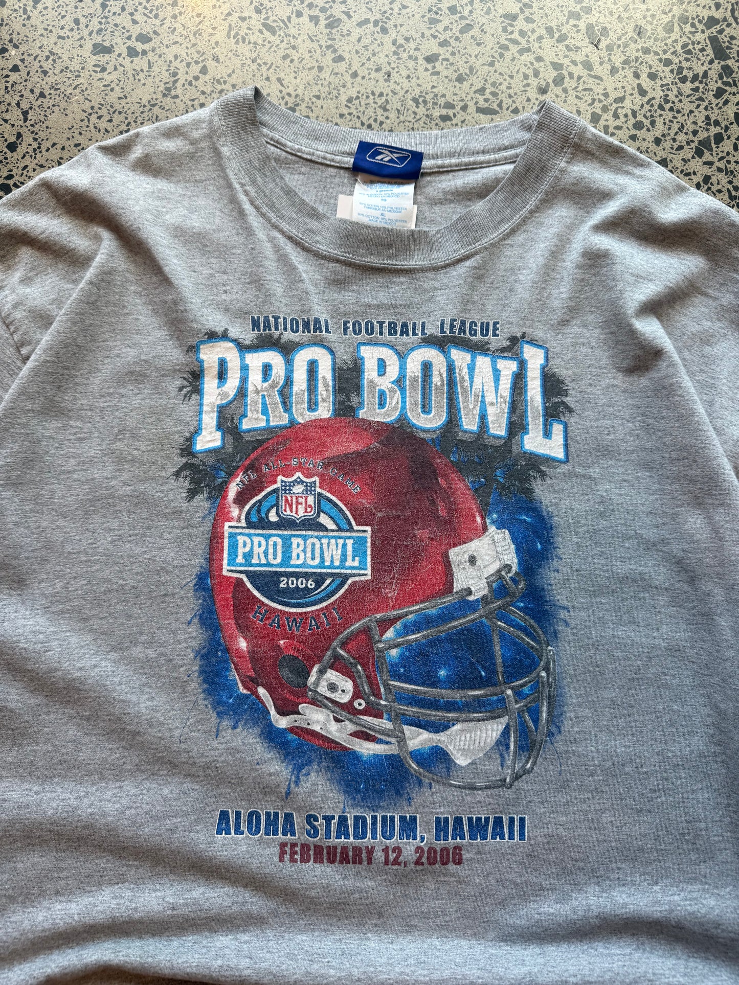 2006 Pro Bowl NFL T-shirt, size XL, laid on polished concrete background — bold mid-2000s football graphic on soft cotton.
