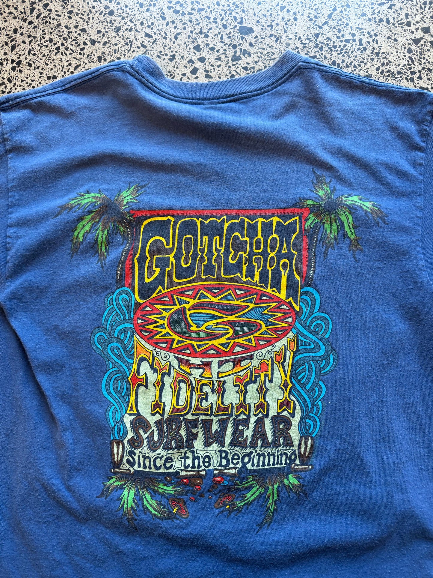 Vintage 90s Gotcha Surf blue t-shirt with bold colourful back graphic and subtle chest logo. Size L. Classic surfwear