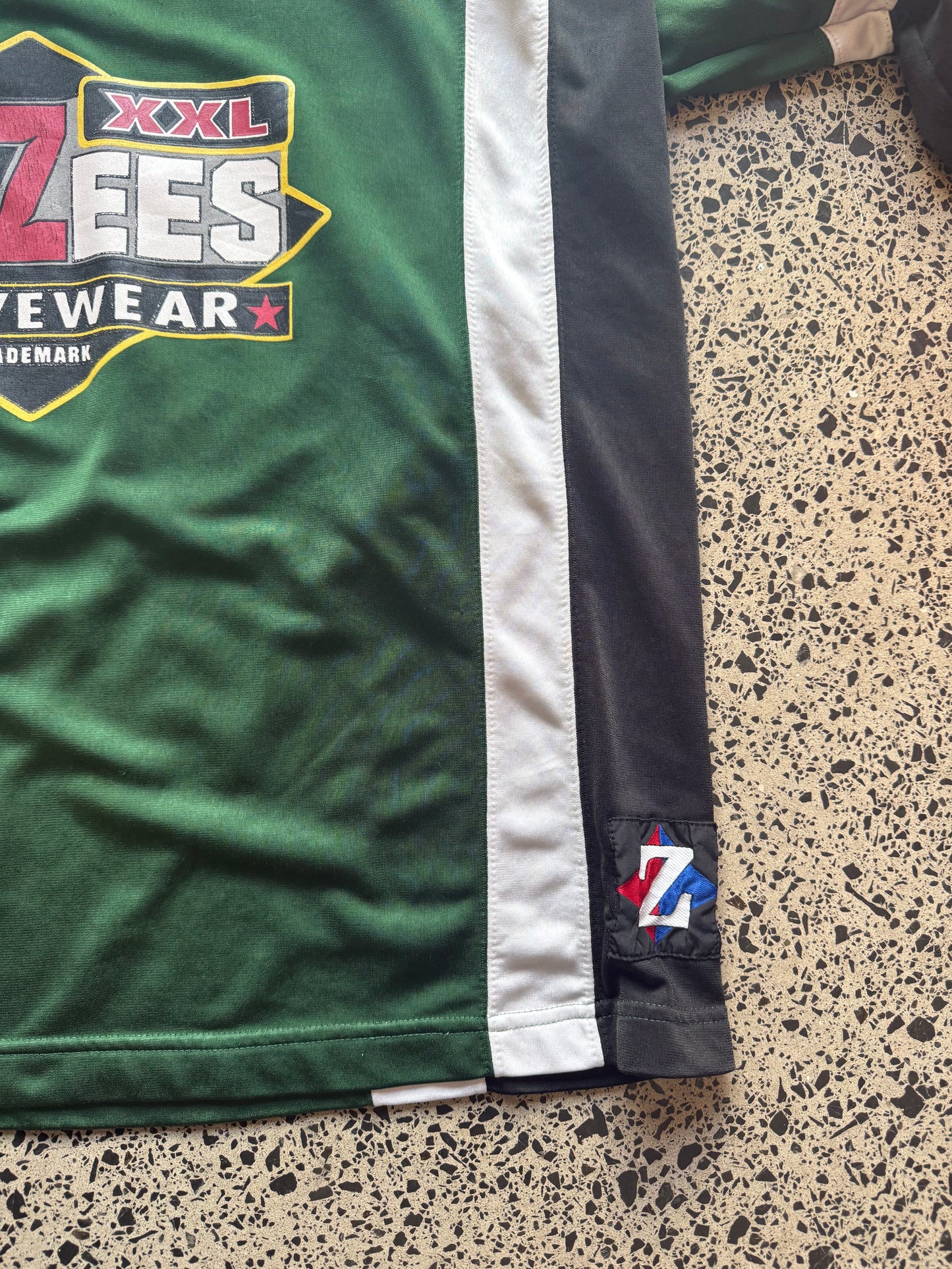 Front view of vintage 90s Jerzees NHL-style black, red, and white sports jersey in XL, laid flat on white background