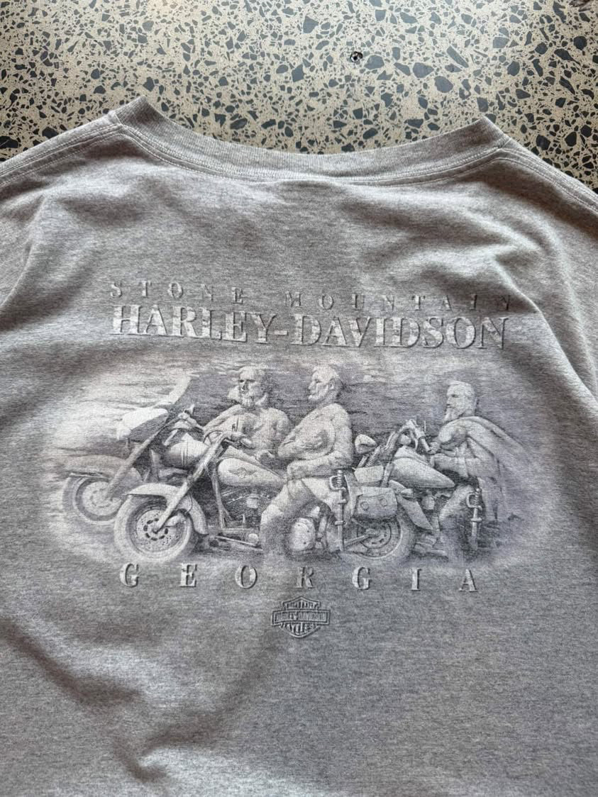 Harley-Davidson graphic T-shirt in size L laid flat on a polished concrete background featuring bold motorcycle-inspired branding