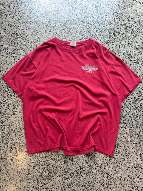 2007 Lucas Oil graphic T-shirt laid on a polished concrete background featuring bold motorsport logo artwork.