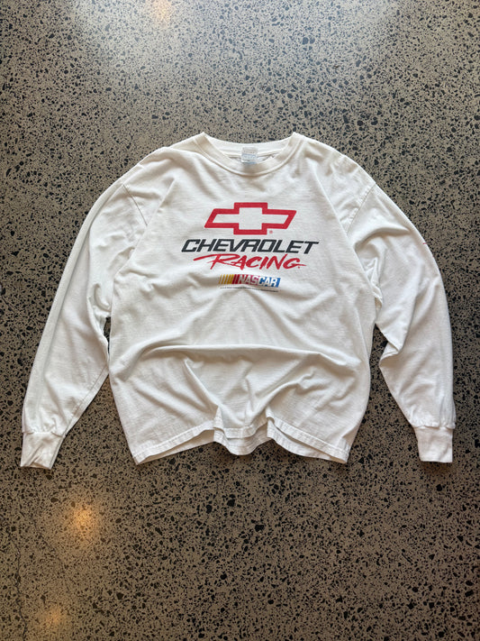 Early 2000s Chevrolet Racing NASCAR XL shirt laid flat on polished concrete background, vintage motorsport tee with bold Chevrolet branding and racing-inspired graphics.