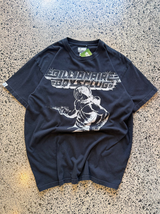 Billionaire Boys Club astronaut T-shirt in black, size M, laid on a polished concrete background — bold white astronaut graphic on soft cotton.