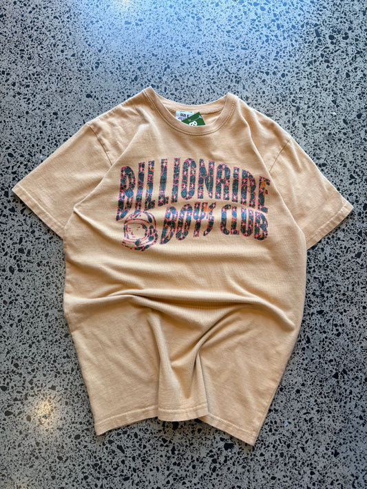 2022 Billionaire Boys Club tan logo T-shirt, size L, laid on polished concrete background — soft cotton with bold chest print.
